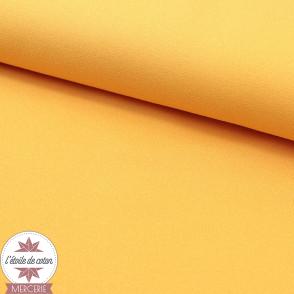 Tissu crêpe polyester uni jaune kumquat